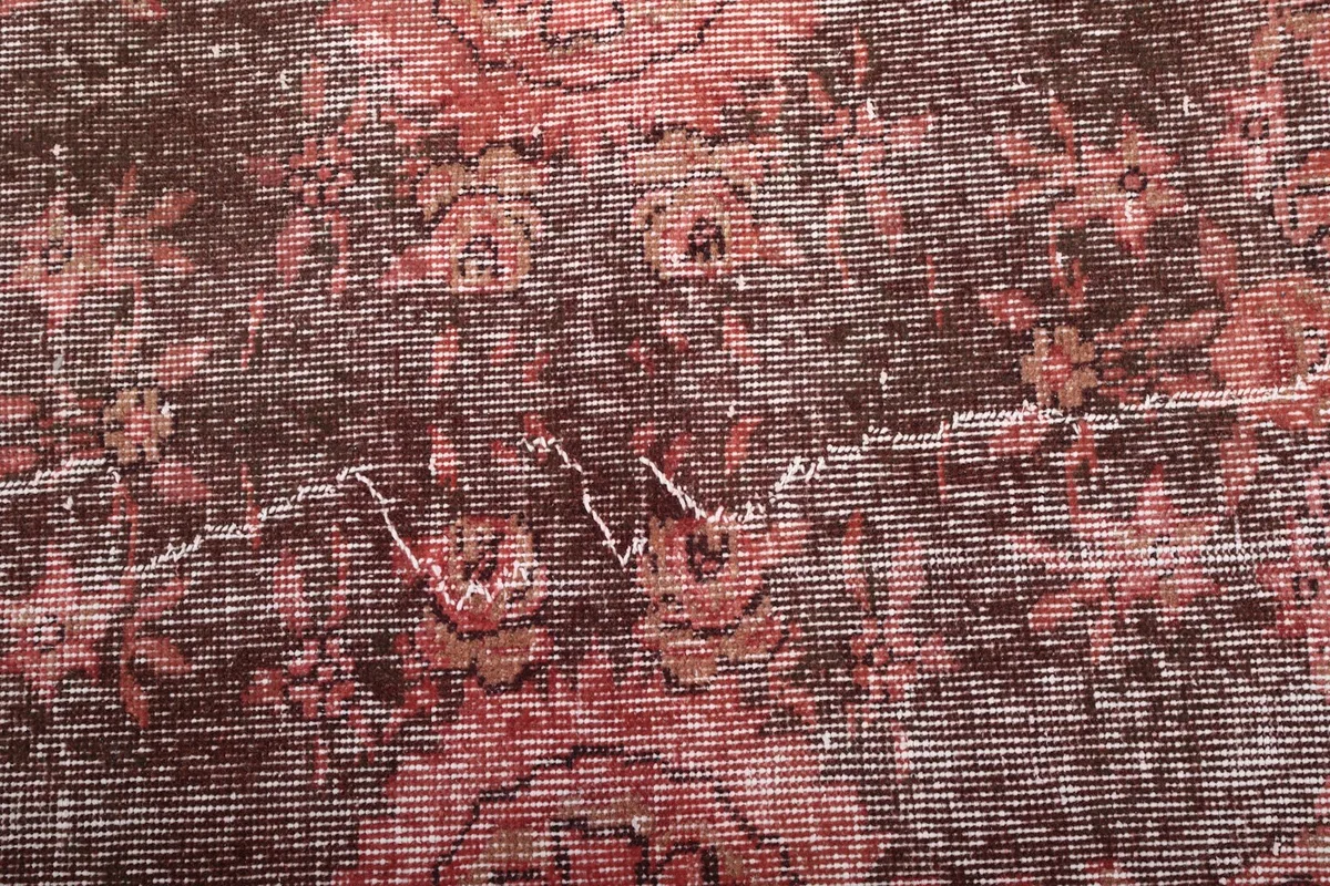 Detailed texture of the low wool pile and worn patterns