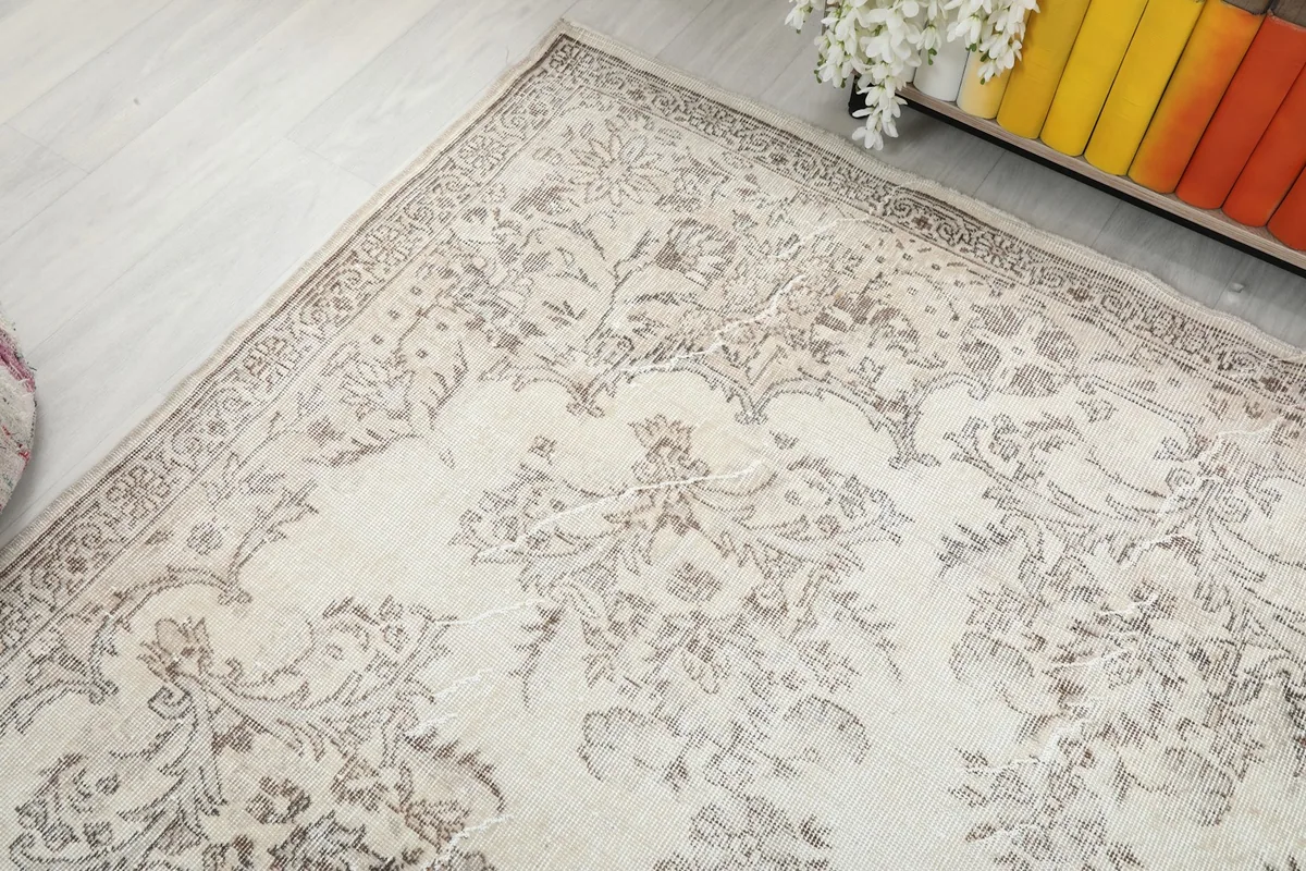 Overhead angle of the vintage rug highlighting its overall floral design and soft colors
