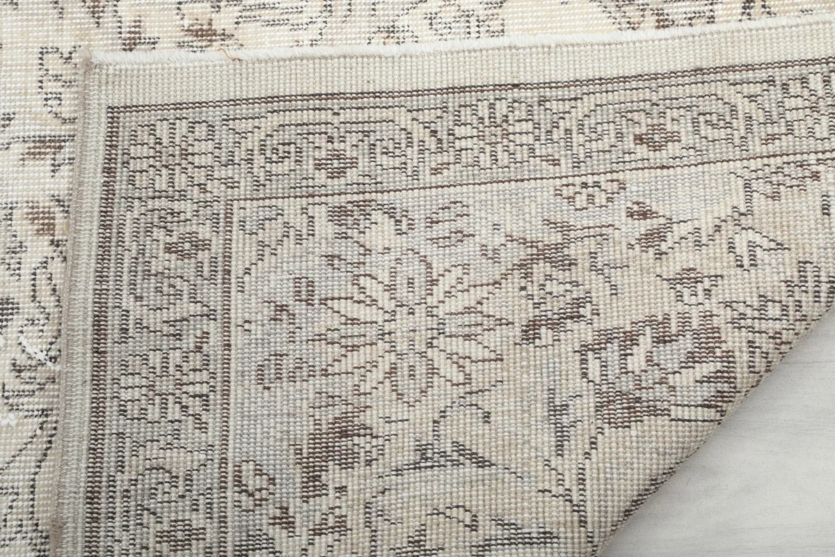 Close-up of the rug's back, revealing the hand-knotted cotton foundation
