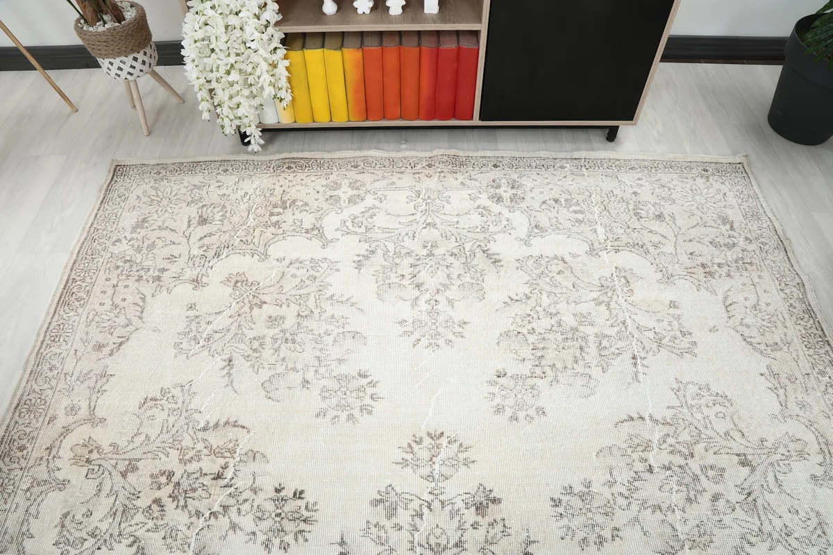 Overhead view of the ivory Anatolian rug in a room, showing its full design