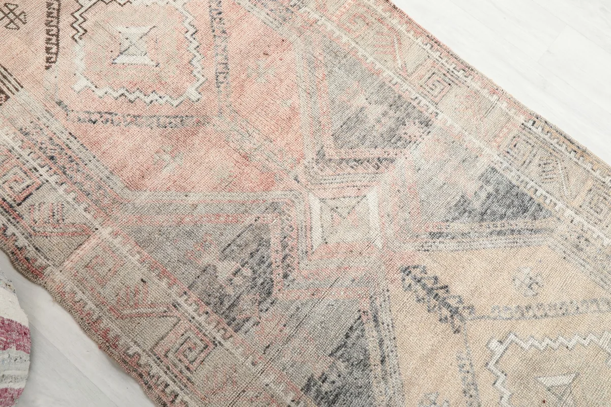 Overhead angle showing the color variations from beige to pink in the rug's body