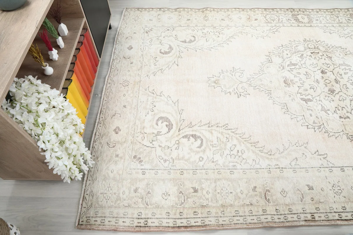 Angled shot emphasizing the rug's soft color transitions and overall distressed character
