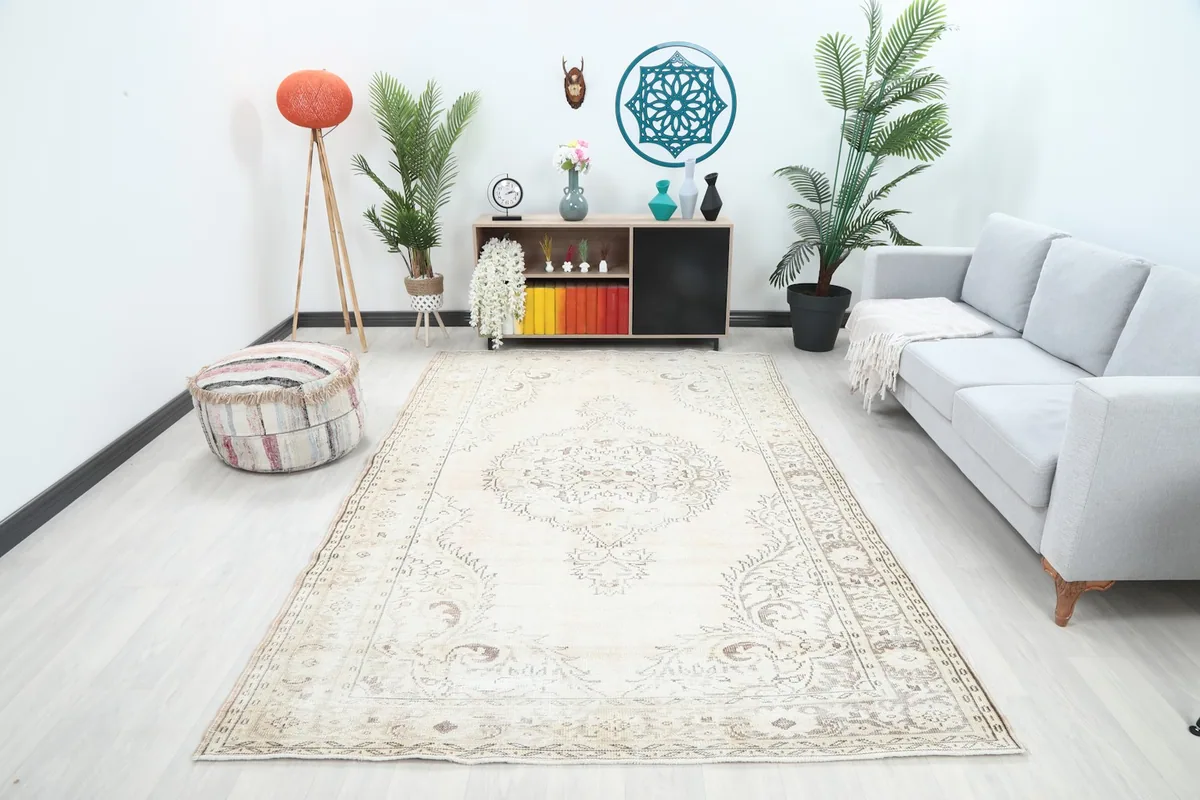 Vintage Anatolian rug in an open room setting, showcasing its large size and ivory tones