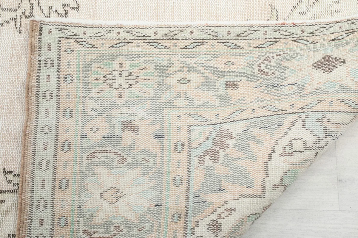 Detailed view of the rug's back, showing the hand-knotted construction and foundation
