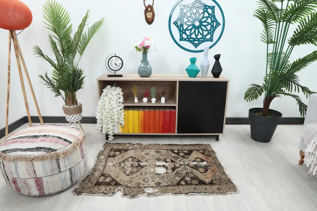 Vintage Anatolian rug displayed in a room setting, placed in front of a modern console table.