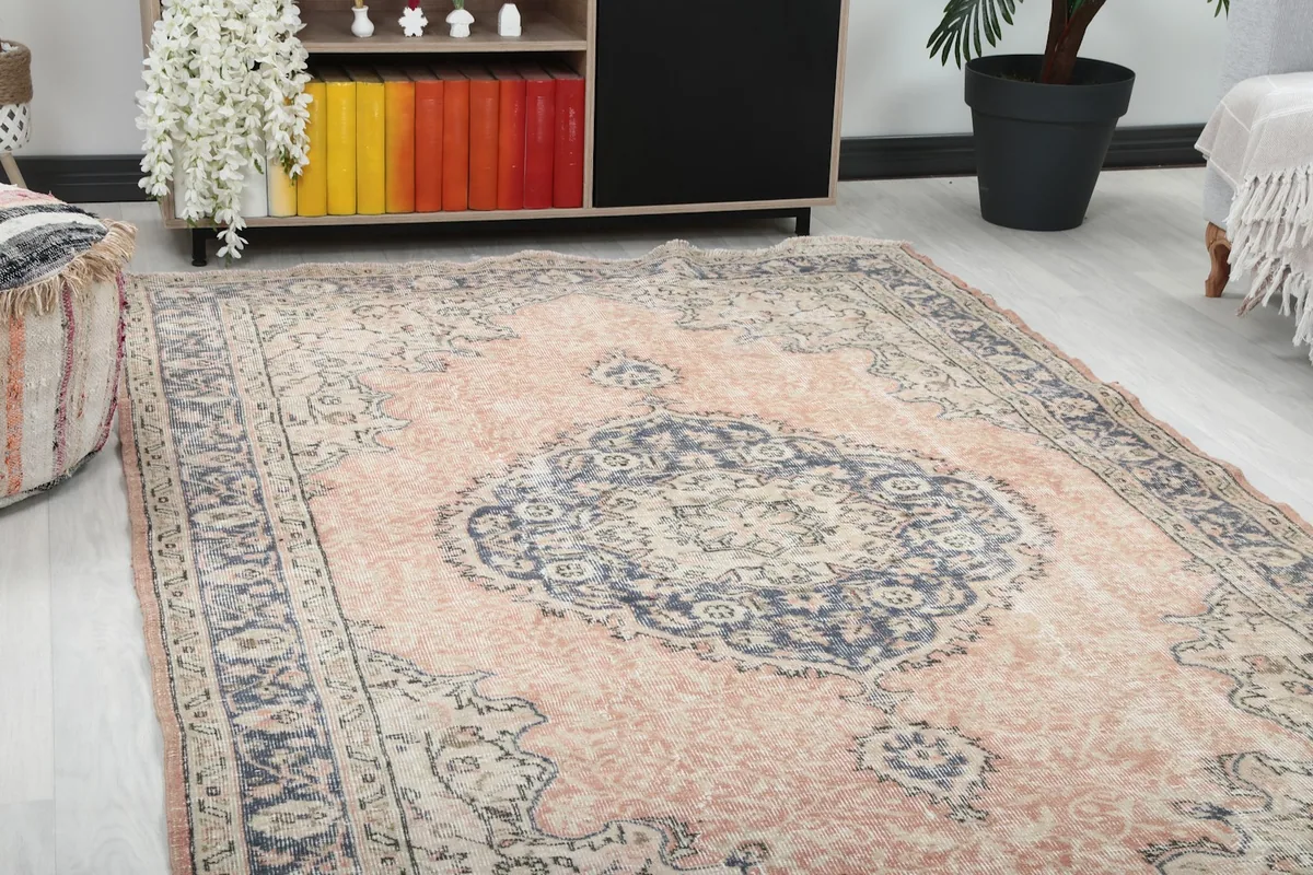 Close-up angled view of the rug's central medallion and surrounding rose field, showing details and colors.