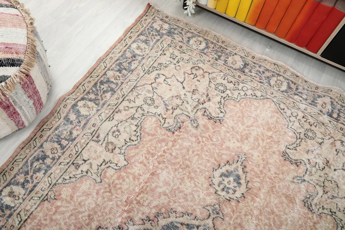 Top-down angled view showing one corner of the rug, revealing the border and field patterns.