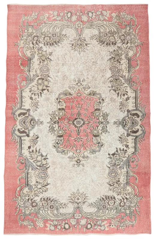 Full overhead view of the vintage rose and ivory Anatolian rug on a white background