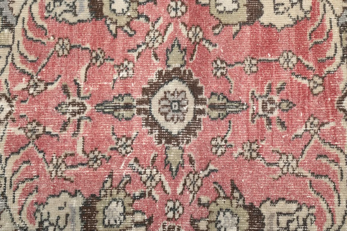 Close-up of the intricate floral design within the rose central medallion
