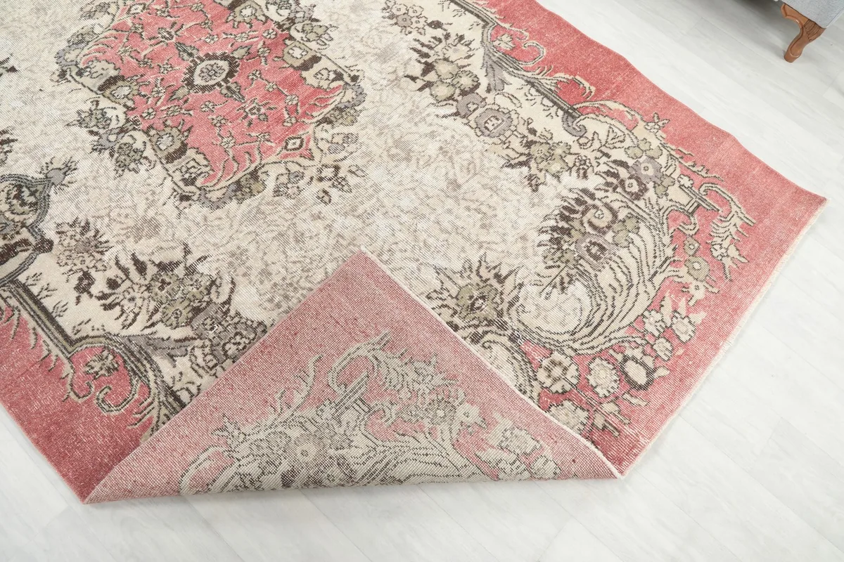 Corner of the rug folded back, revealing the reverse side and construction