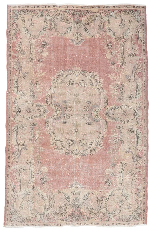 Full overhead view of the vintage rose and beige medallion area rug