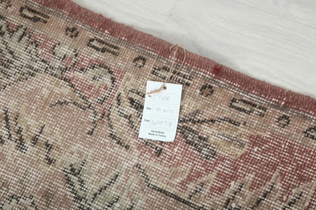 Tag on the back of the rug, detailing its origin and material composition