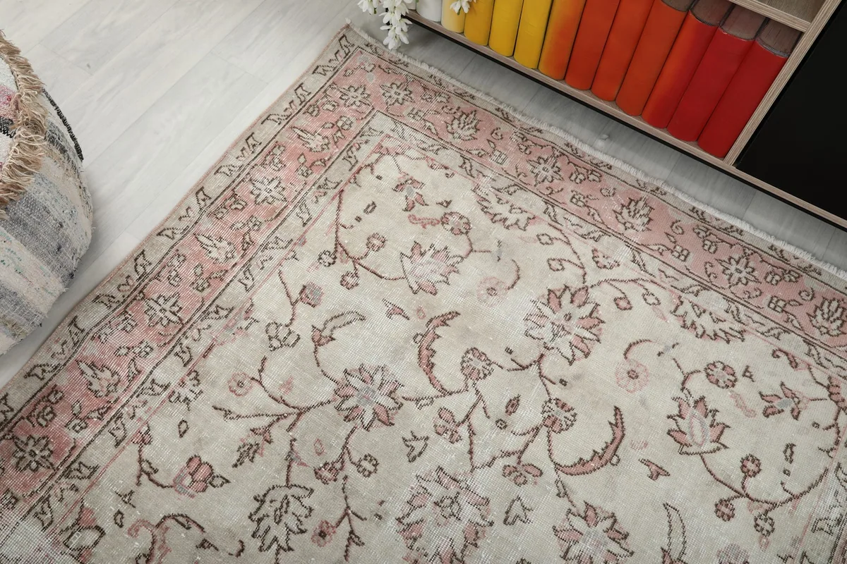 Corner view of the rug showing the rose border and floral field pattern