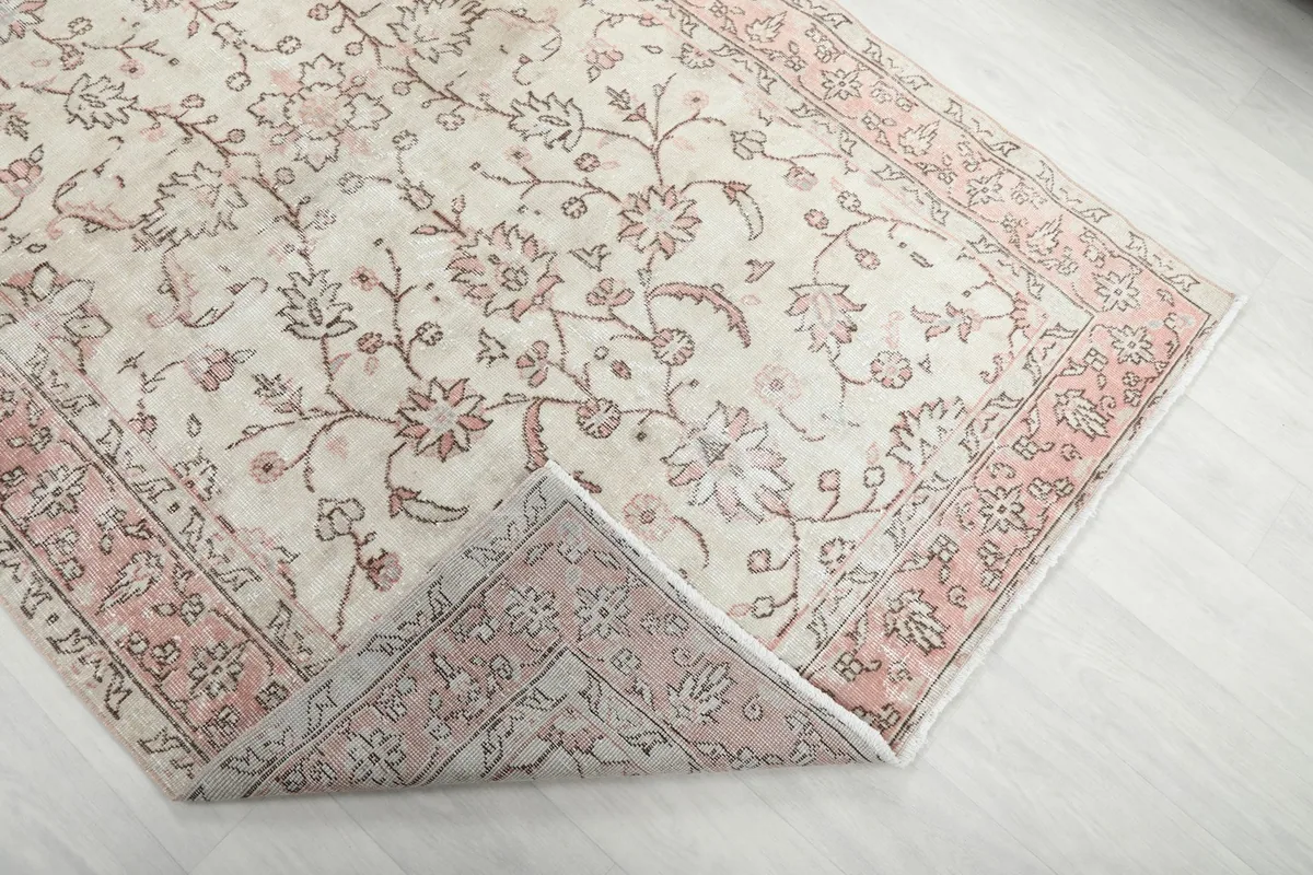 Close-up showing the low pile and hand-knotted wool texture of the rug