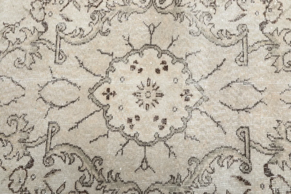 Close-up of the central medallion design on the ivory field