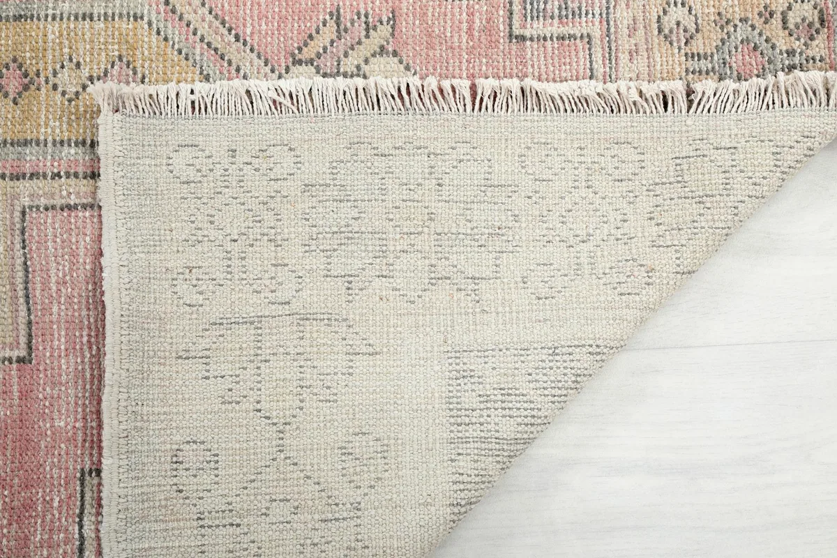 Close-up of the back of the rug, showing the dense hand-knotting and fringe detail