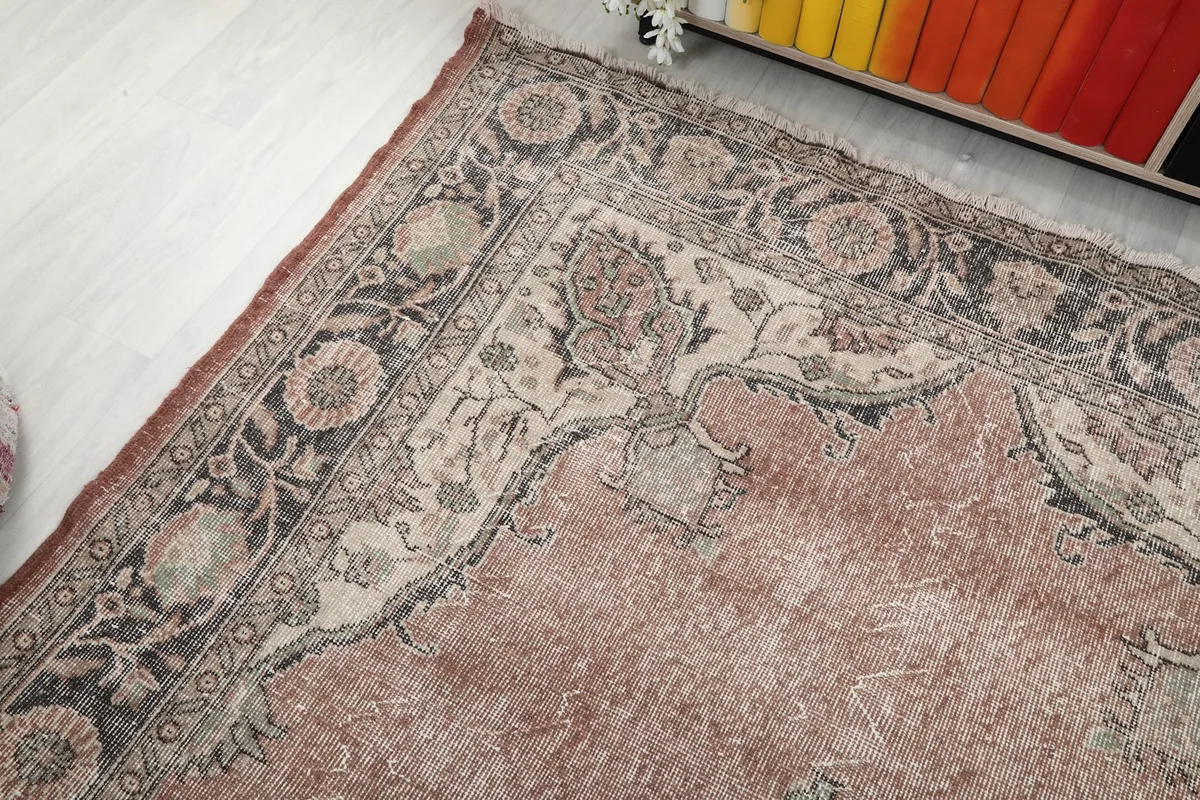 Corner view of the rug showing the subtle color variations and faded pile