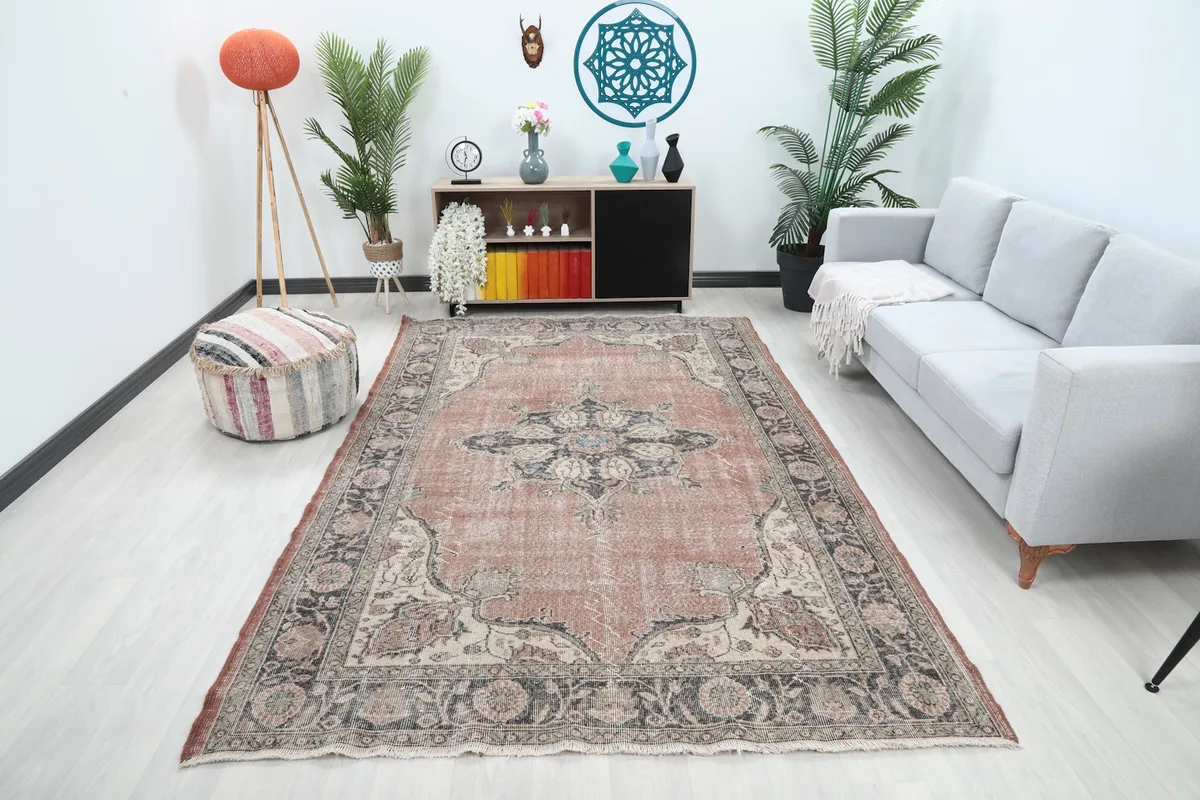 Vintage rust rug in a modern living room setting with a light gray sofa
