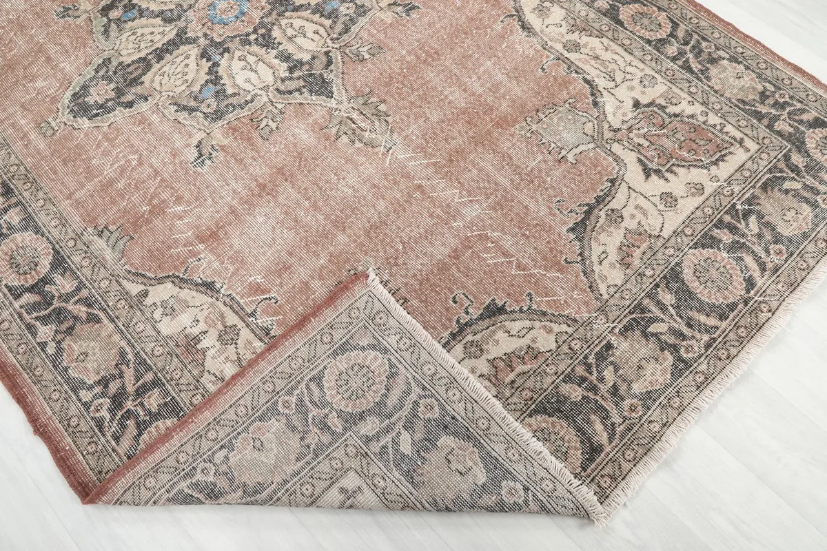 Folded corner of the rug revealing the cotton foundation beneath the wool pile