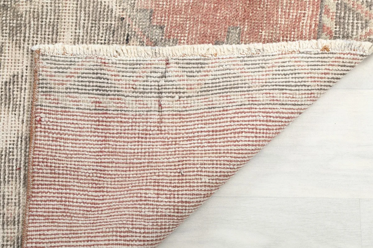 Underside of the runner rug, showing the hand-knotted cotton foundation