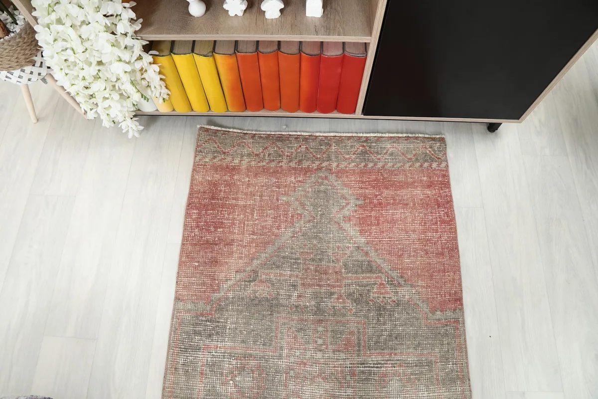 Overhead view of one end of the runner rug, showcasing the faded colors and patterns