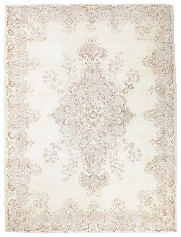 Full overhead view of the ivory and tan floral medallion vintage Anatolian rug