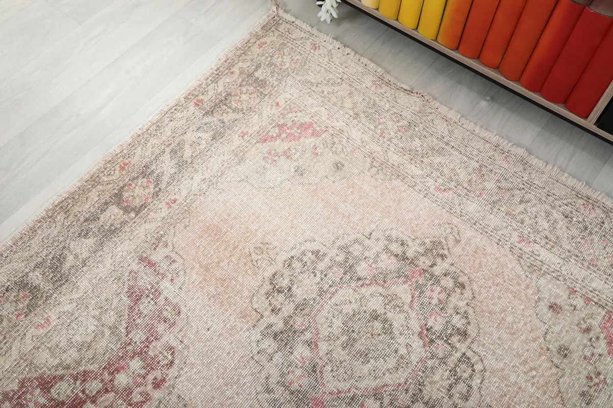 Angled view of one end of the runner rug, showing the border design and color variation