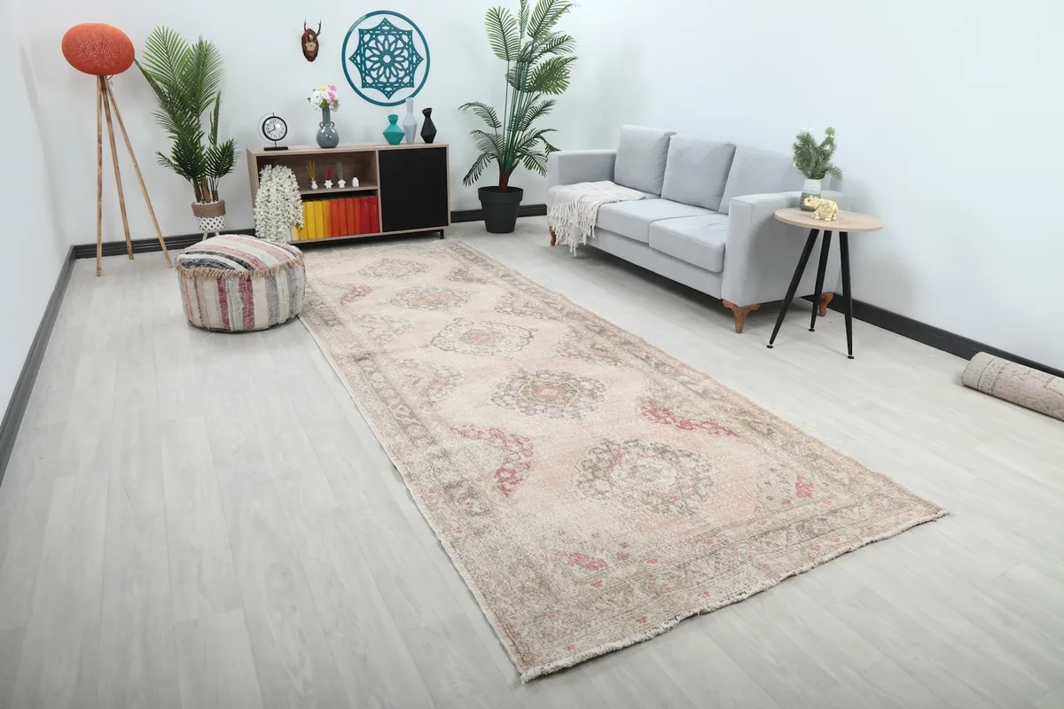 Long view of the Anatolian runner rug extending through a room, showing its length