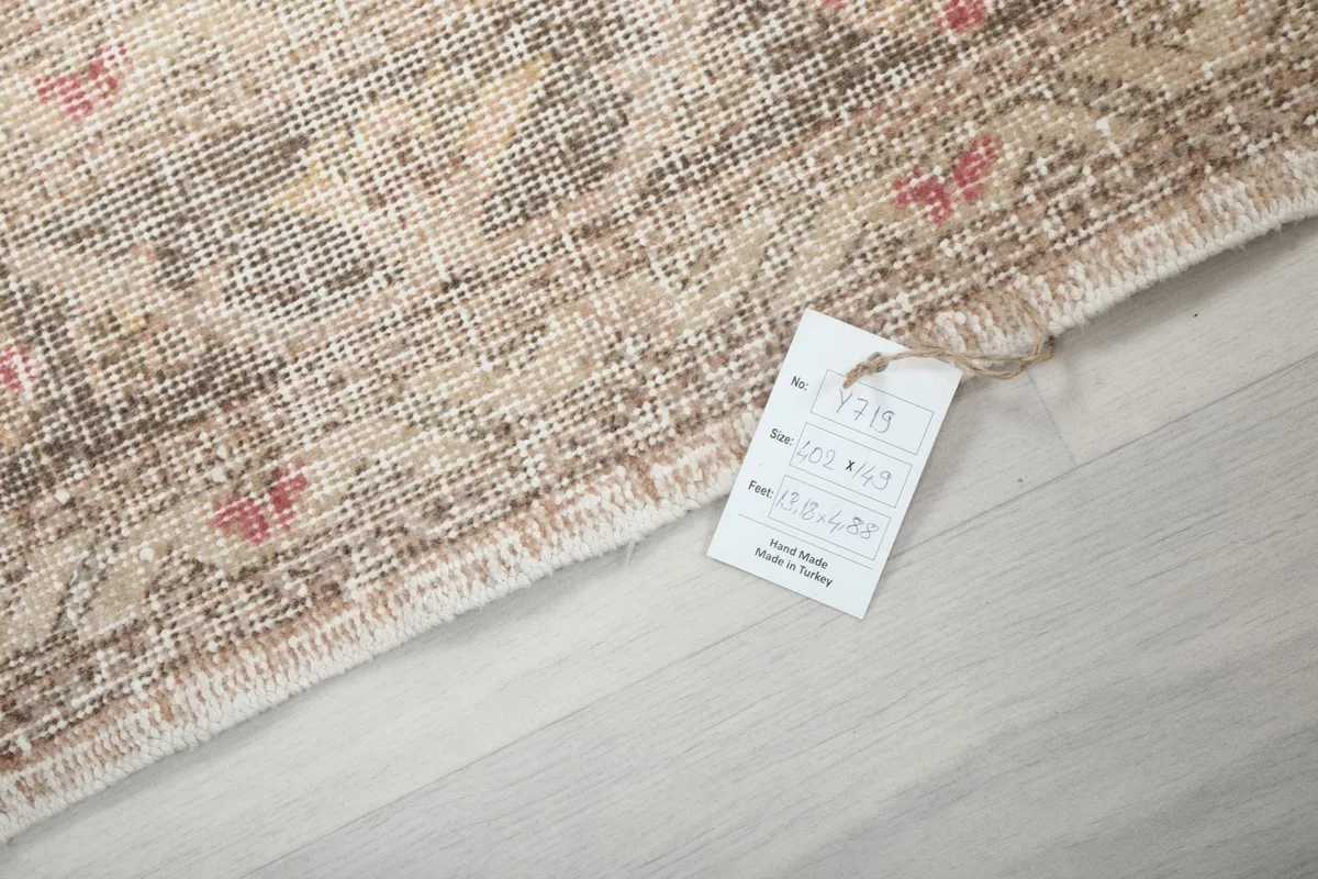 Corner of the rug with a product tag, showing the texture and fringe
