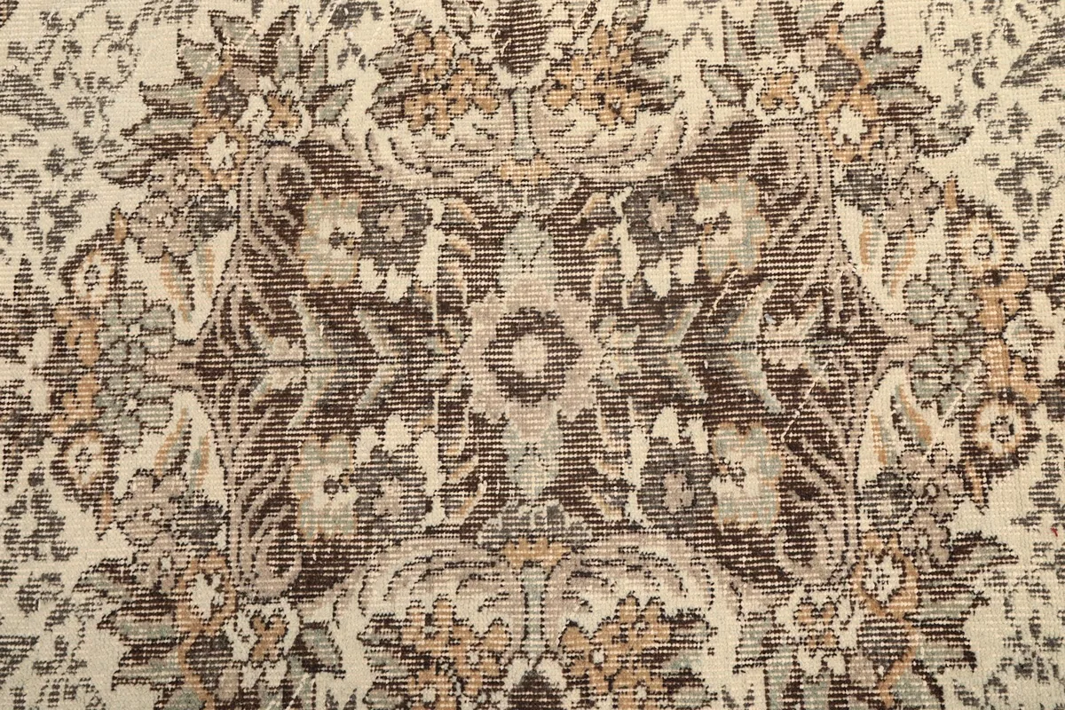 Close-up of the intricate floral and vine patterns in the rug's center