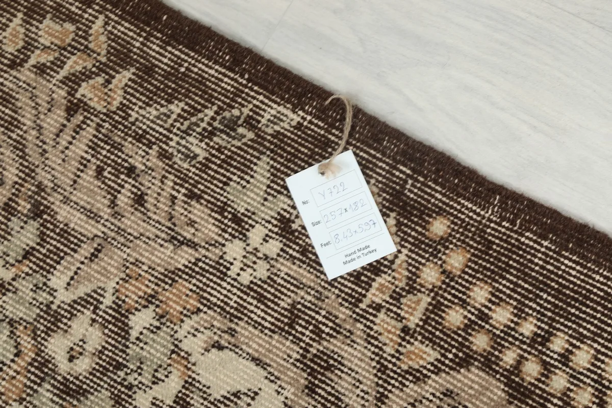 Care tag attached to the corner of the hand-knotted vintage rug