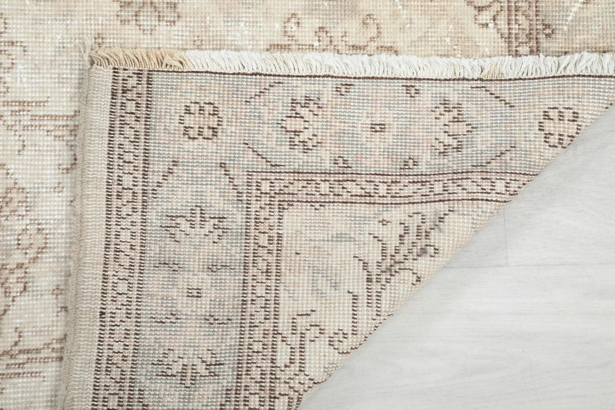 Detailed view of the rug's back, revealing the hand-knotted construction and fringe