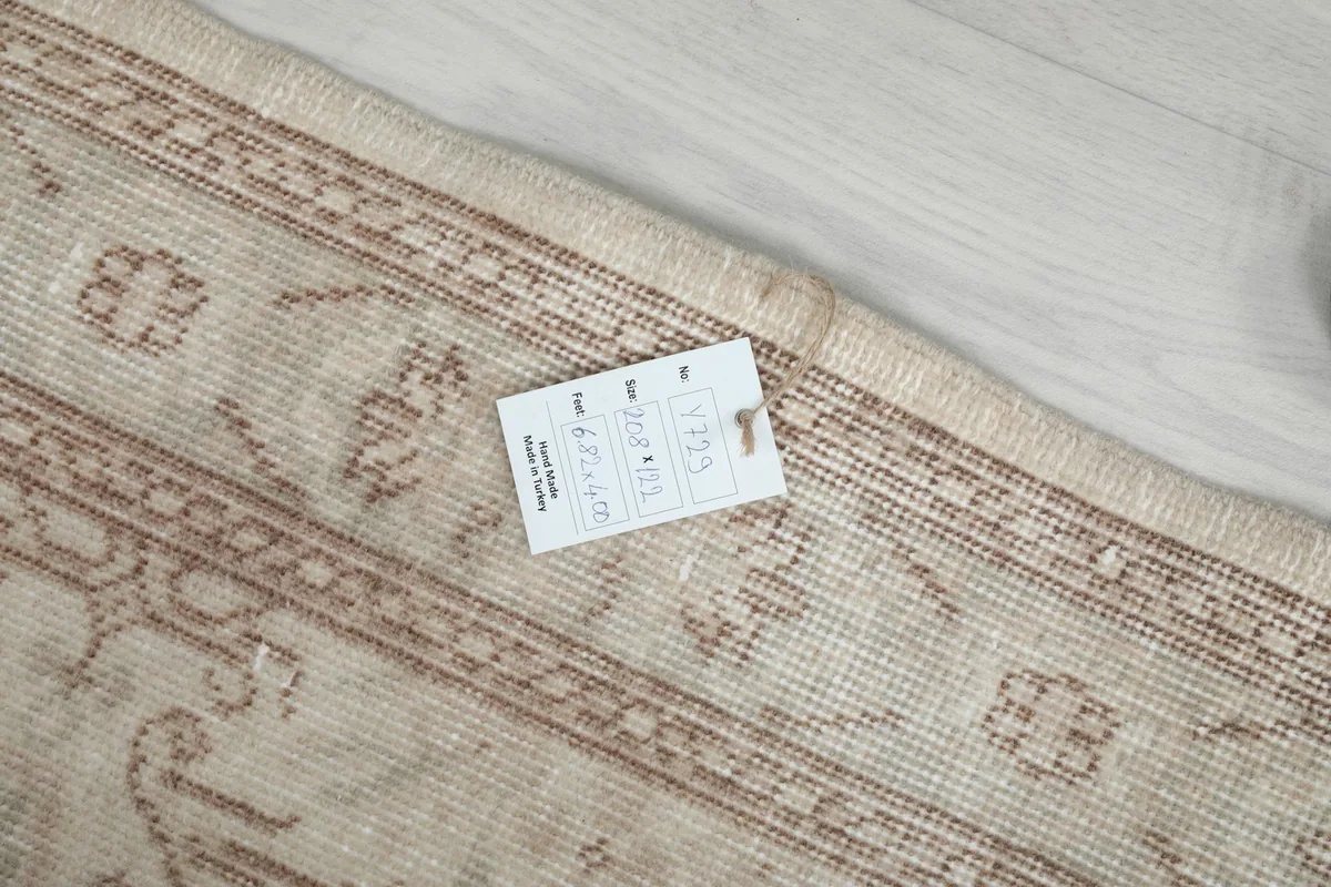 Close-up of the rug's edge with a tag showing product information and details
