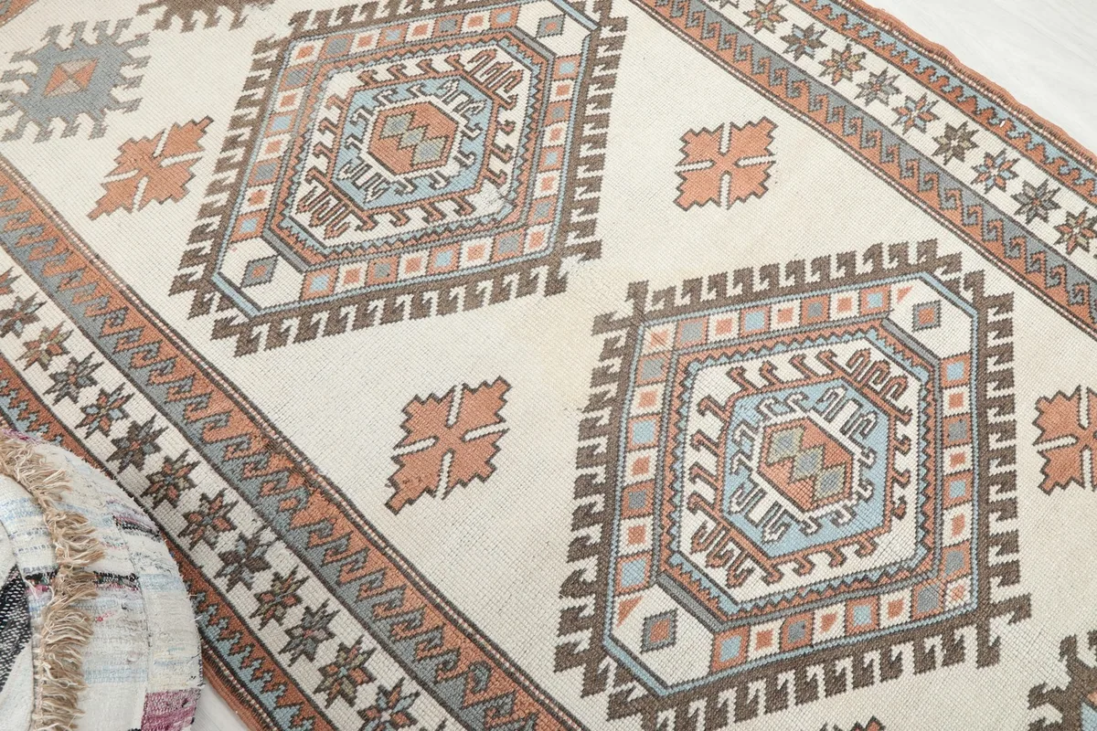 Angled view highlighting the large central diamond motifs and scattered orange patterns.