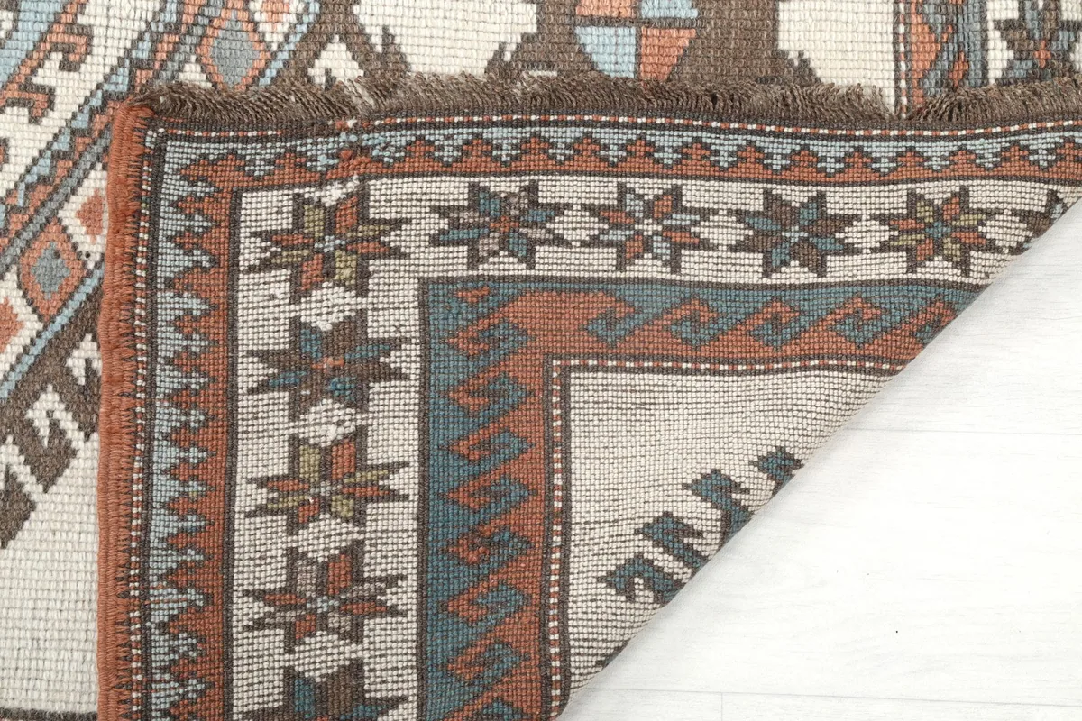Underside of the rug's corner, showing the tight hand-knotted construction.