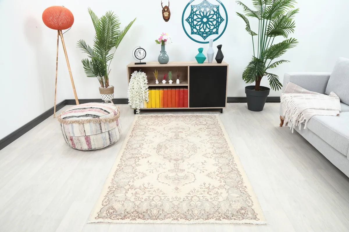 Vintage rug in a light-filled living room setting, showing its scale and color