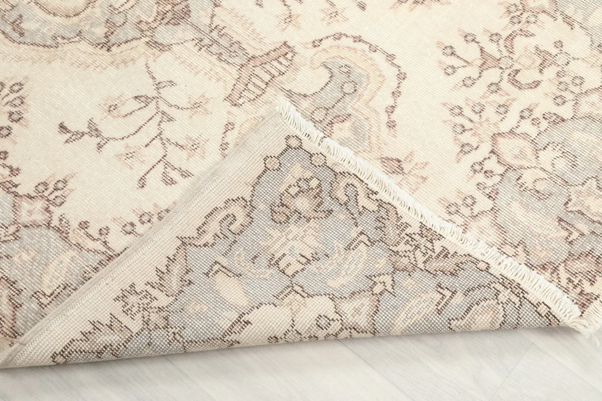 Close-up of the rug's low wool pile and the hand-knotted construction
