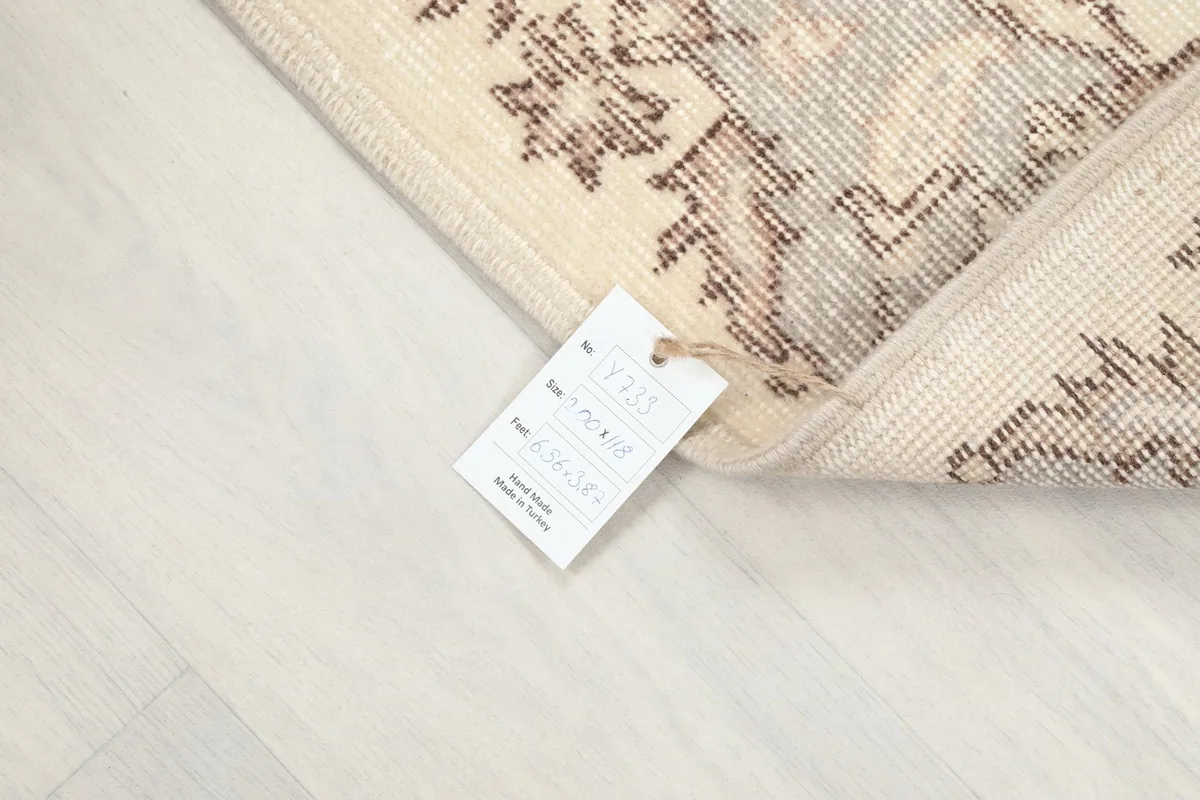 Corner of the rug with the product tag showing size and material information