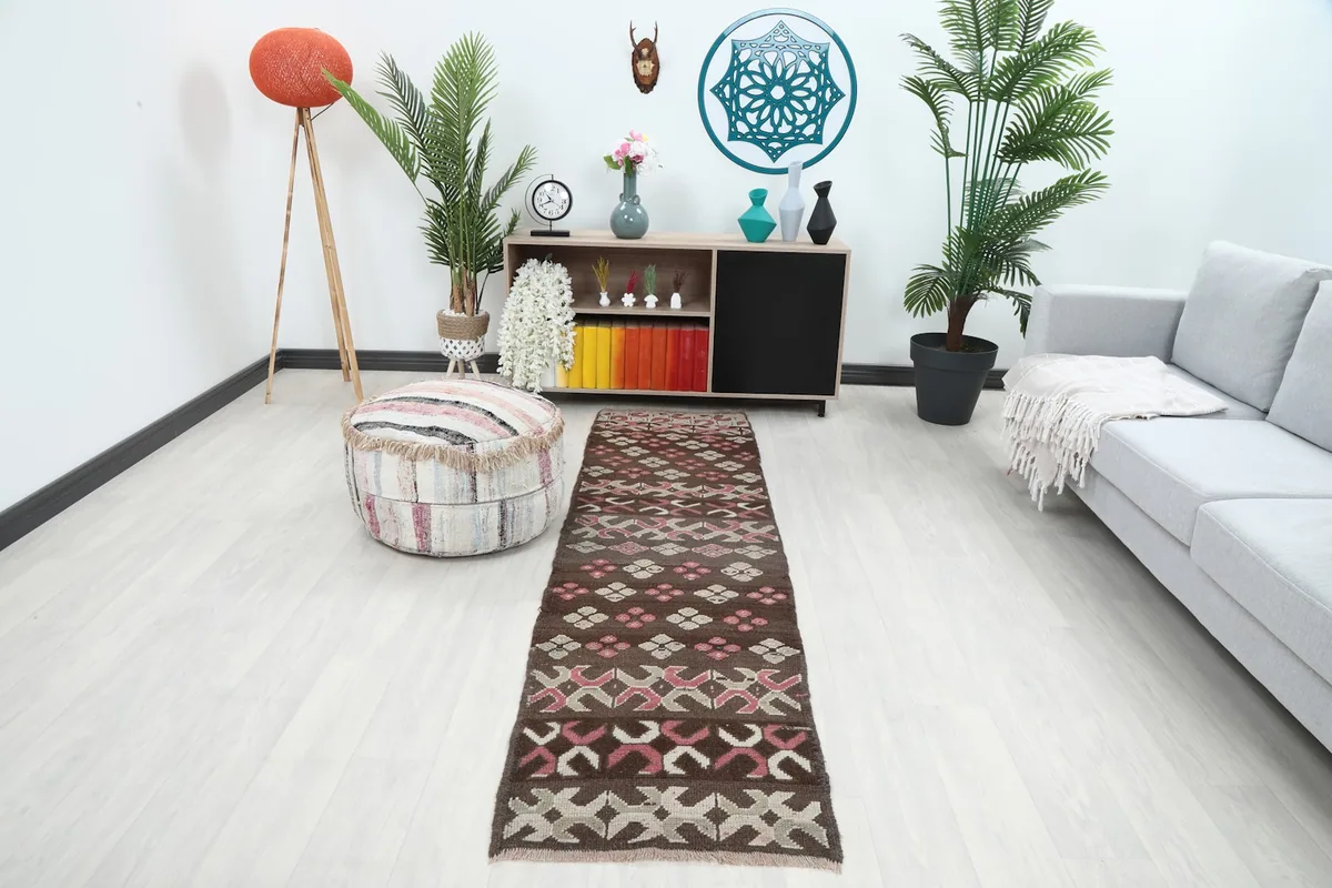 The runner placed in a modern living room setting, showcasing its length and colors.