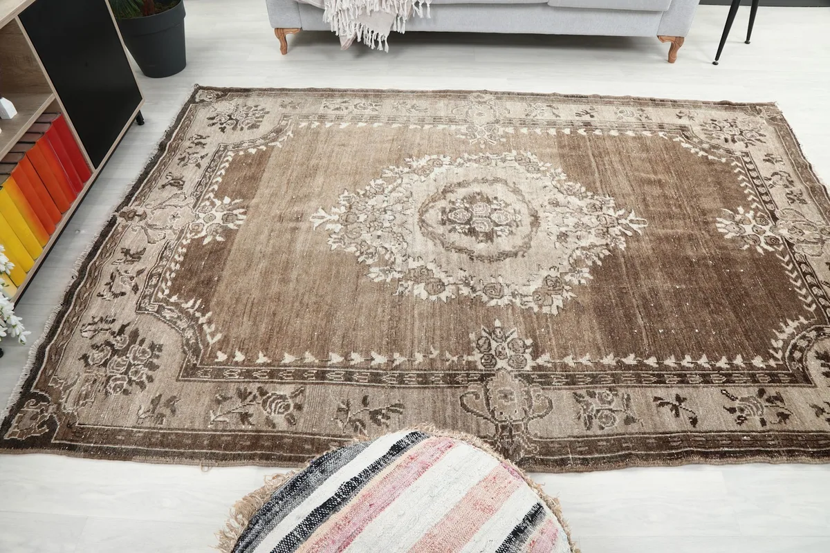 Wide shot of the brown and beige rug in a room, showing its scale