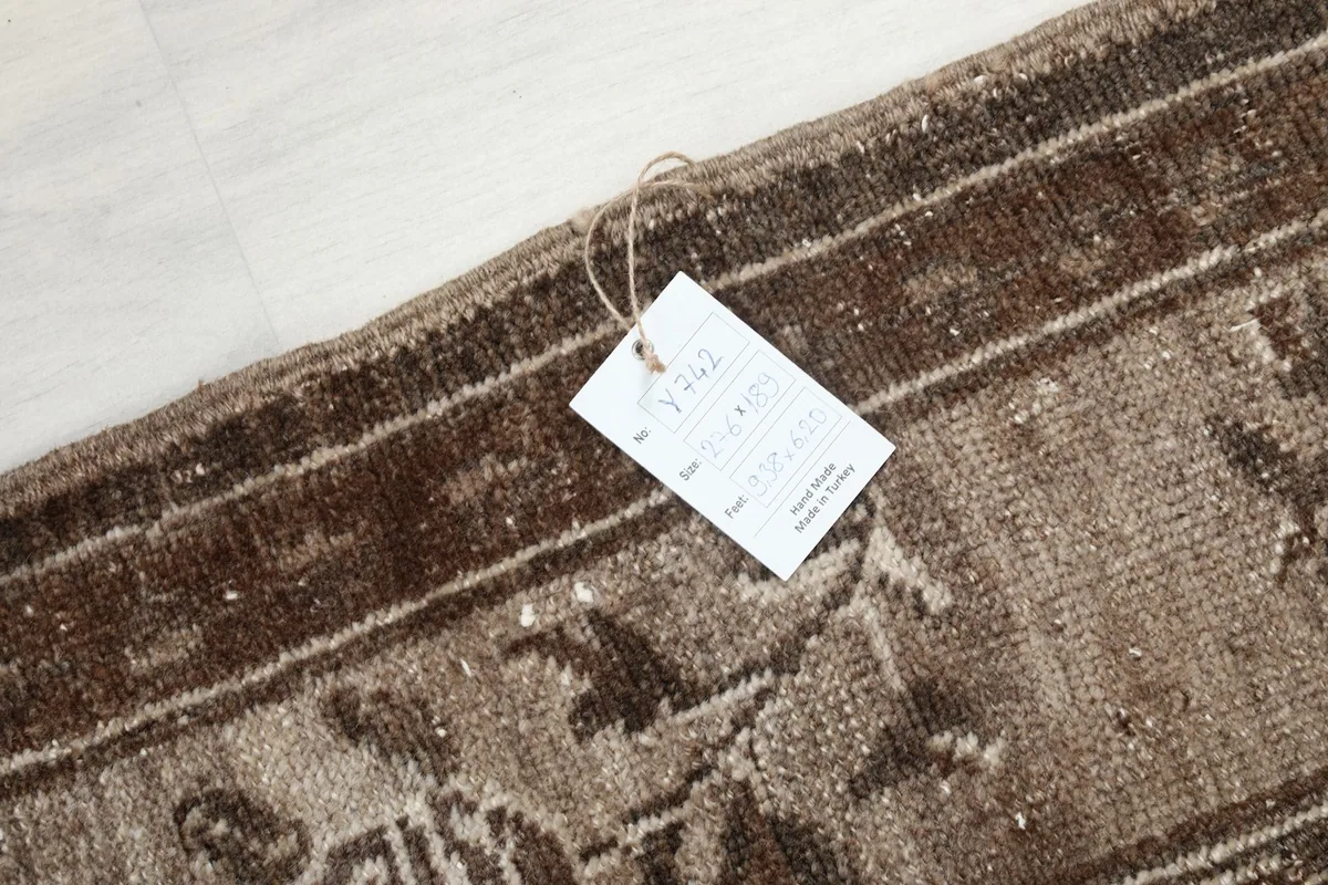 Close-up of the rug's label attached to the edge, showing product details