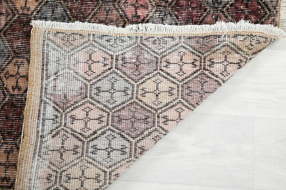Another view of the rug's underside, showing the consistent knotting and the quality of the vintage wool on cotton.
