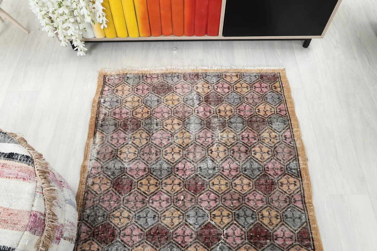Overhead shot of one end of the rug, displaying the full width of the geometric pattern.