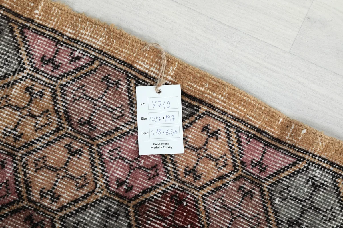 Close-up of the product tag attached to the rug, displaying item number, size, and material information.