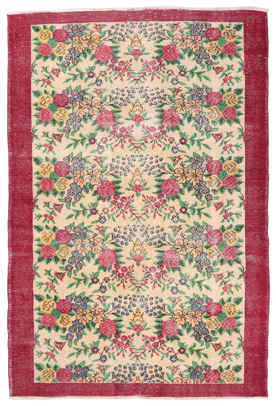 Full overhead view of the vintage cream and red floral Anatolian rug on a white background.