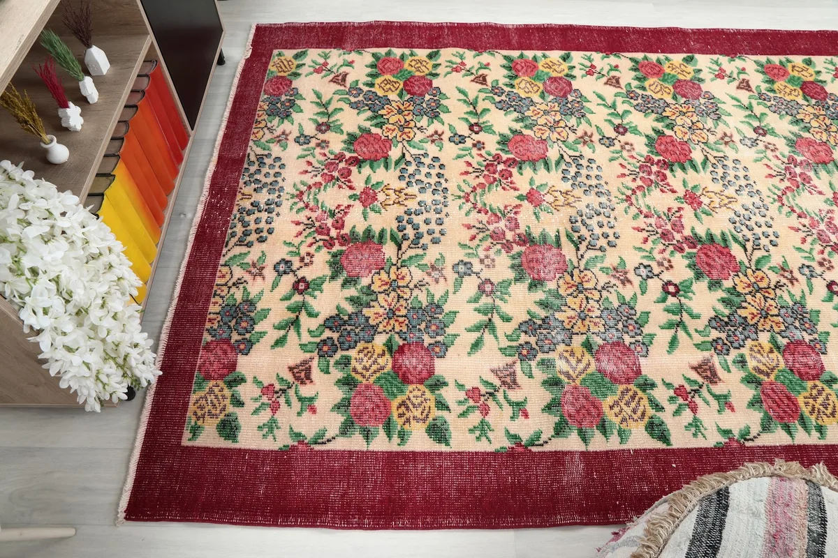 Wide angle shot of the vintage rug in the room, showing its dimensions and interaction with light.