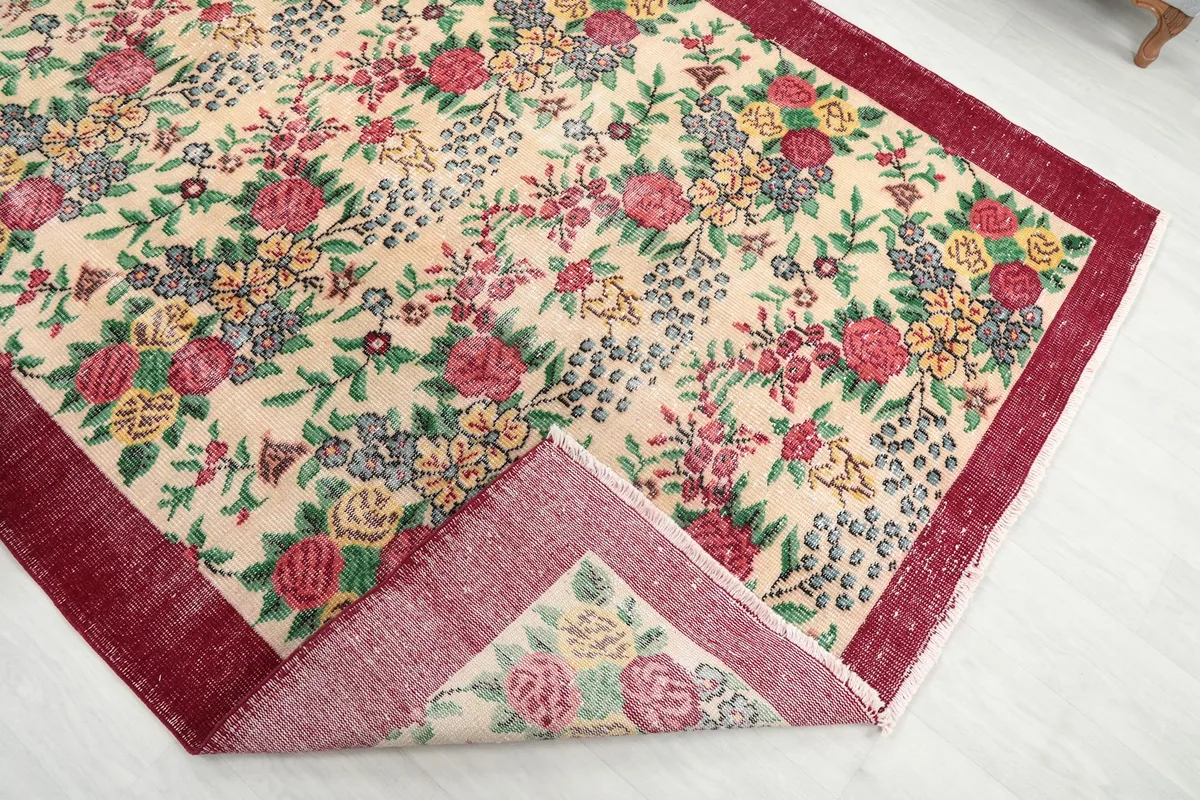 Underside view of the rug corner, revealing the cotton foundation and hand-knotted construction.