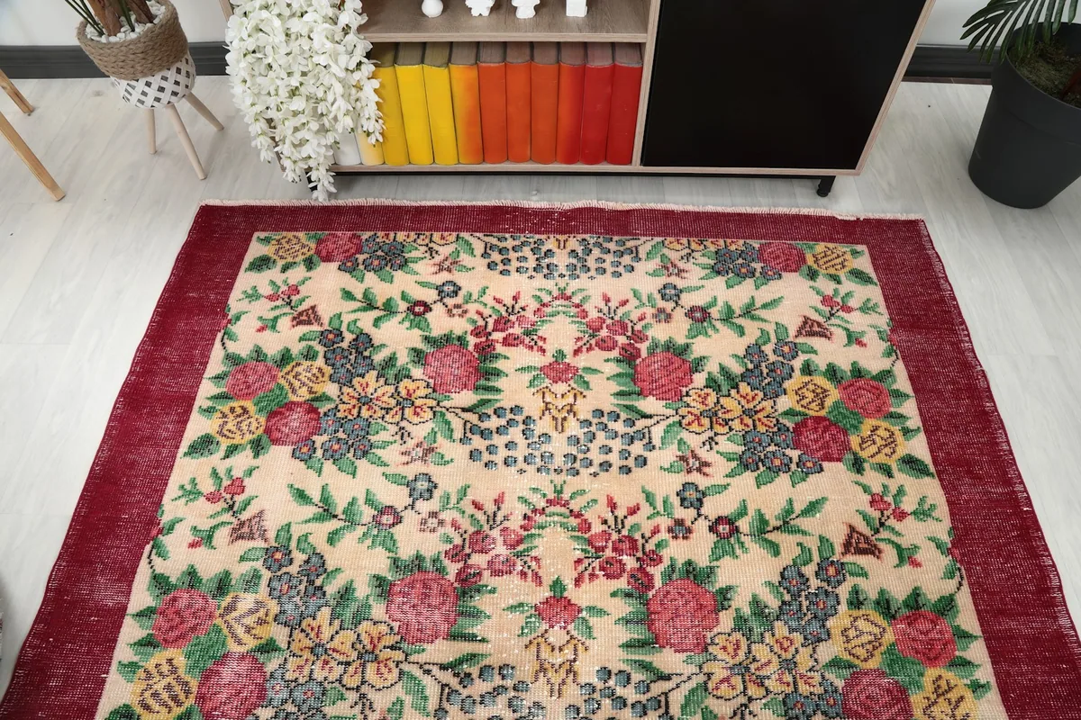 Overhead view of the rug in a room, showcasing the full floral design and vibrant colors.