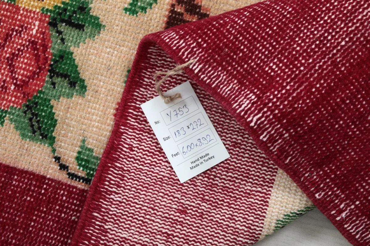 Folded corner of the rug with a tag showing product details and country of origin.