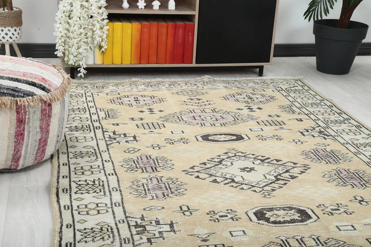 Close-up of the Beige Tribal Geometric Rug, highlighting the faded rose and charcoal motifs.